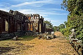 Angkor - Eastern Mebon - towered passageways leading to the first enclosure of the temple,  with stone lions guarding the entrance.